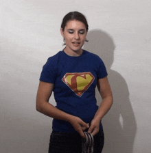 a woman wearing a blue superman t-shirt