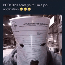 a bucket filled with a job application form is sitting on a table .