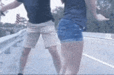 a man and a woman are dancing on a highway .