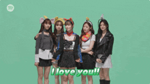a group of girls standing next to each other with the words " i love you " on a green background