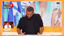 a man with a beard is dancing on a tv show called touche pas a mon poste