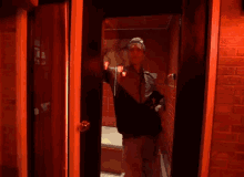 a man standing in front of a door with red lights on