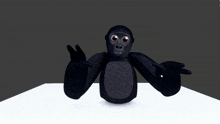 a stuffed gorilla sitting on a white surface