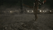 a man in a leather jacket is holding a bat that says " rick grimes " on it