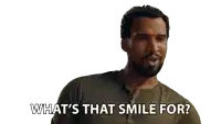 a man with a beard is smiling and says what 's that smile for