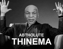 a black and white photo of mike tyson with the words abtholute thinema behind him