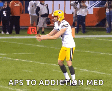 a football player on the field with the words aps to addiction med above him
