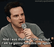 a man is holding a microphone and saying " oh my god "