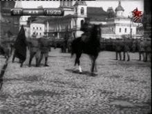 a black and white photo of a man riding a horse with the date 1911
