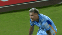 a soccer player wearing a light blue jersey with the word adidas on the front