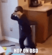 a child is dancing in a kitchen with the words hop on dbd on the bottom