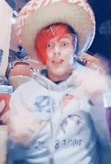 a man with red hair wearing a sombrero and a sweatshirt that says infinite