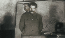 a black and white photo of a man stands in front of a map that says " smithsonian channel "