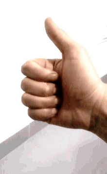a close up of a person 's hand giving a thumbs up sign