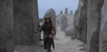a man with a sword and a helmet is running through a rocky area