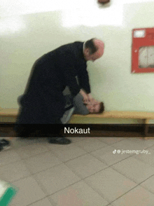 a man is laying on the floor with the word nokauf written on the bottom