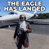 a man standing in front of a plane that says the eagle has landed on it