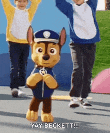 a stuffed animal from the paw patrol movie is dancing with two children .