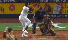 a baseball game is being played in front of an ad for jim beam