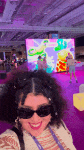 a woman wearing sunglasses has a lanyard around her neck that says ' sydney ' on it