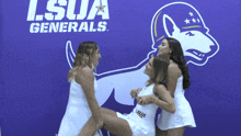 three girls pose in front of a lsua generals sign