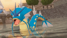 a blue and yellow pokemon swimming in a body of water