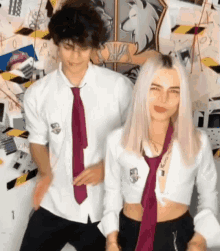 a man and a woman are standing next to each other wearing school uniforms .