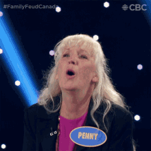 a woman with a name tag that says penny makes a funny face