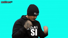 a man wearing a black hat and a black hoodie with the word si on it