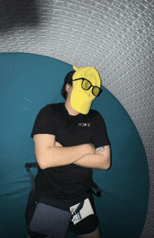 a man wearing a black shirt and a yellow hat with the word ron on it