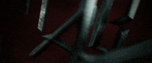 the letter m is being displayed on a dark red background