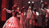 a group of people are dancing in front of a building that says building