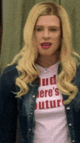 a woman with blonde hair is wearing a denim jacket and a white t-shirt with the word future on it .