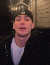 a man wearing a black hat with the letter p on the front