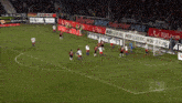 a soccer game is being played in front of a banner that says " hdi gerling "