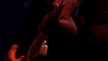a woman singing into a microphone with the words th arms behind her