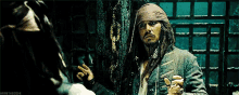 a man with dreadlocks is standing next to another man .