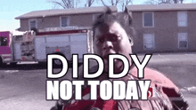 a woman is standing in front of a fire truck with the words `` diddy not today '' written on it .