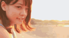 a close up of a woman 's face with the sun shining on her face