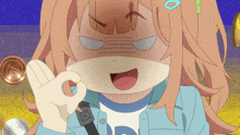 a girl in a blue jacket with the letter d on her shirt giving an ok sign