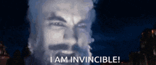 a man with a beard says i am invincible in front of a dark background