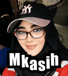 a woman wearing glasses and a ny hat with the word mkasih on it