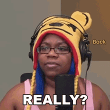 a woman wearing a winnie the pooh hat and headphones says really