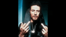 a man is giving the middle finger to the camera .