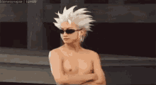 a shirtless man with white hair and sunglasses is standing with his arms crossed and looking at the camera .