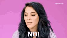 a woman with blue hair says " no " in front of a pink background