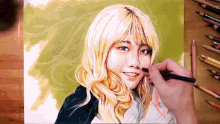 a drawing of a woman with blonde hair is being drawn with colored pencils