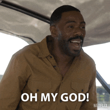 a man in a tan shirt says " oh my god "