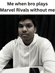a black and white photo of a young man with a caption that says me when bro plays marvel rivals without me