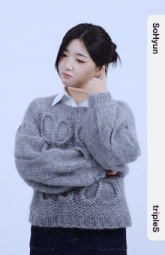 a woman wearing a grey sweater with the name sonyun on the bottom